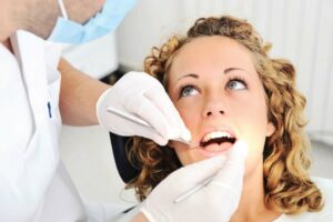 Young woman having her teeth inspected by a dentist - rexburg wellness center