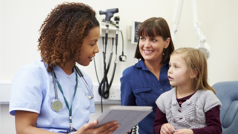 a doctor talking to a girl and her mother - Rexburg Medical Center and Wellness Center Services